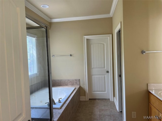 bathroom featuring crown molding, tile patterned flooring, vanity, and a garden tub