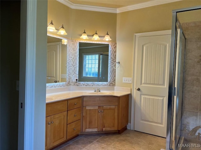 bathroom with double vanity, a stall shower, tile patterned flooring, crown molding, and a sink