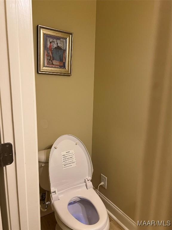 bathroom featuring toilet and baseboards