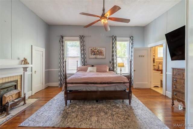bedroom with ceiling fan, baseboards, and wood finished floors