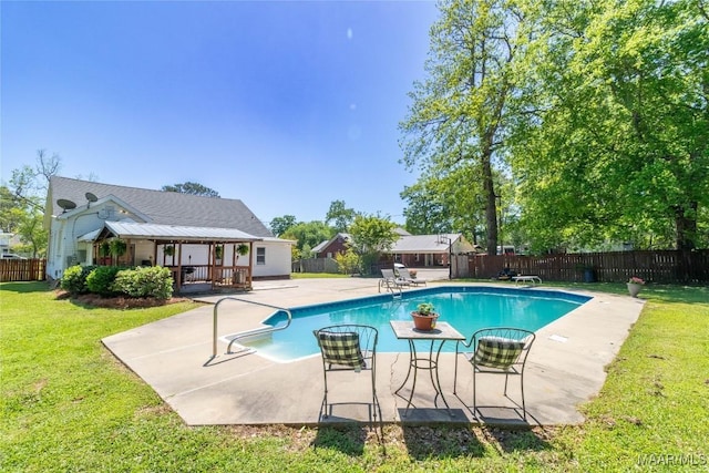 view of swimming pool featuring a fenced in pool, a patio, a fenced backyard, and a lawn