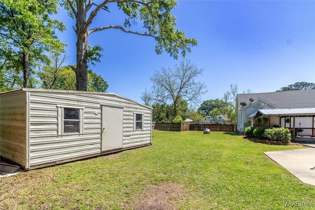 view of yard with fence and an outdoor structure