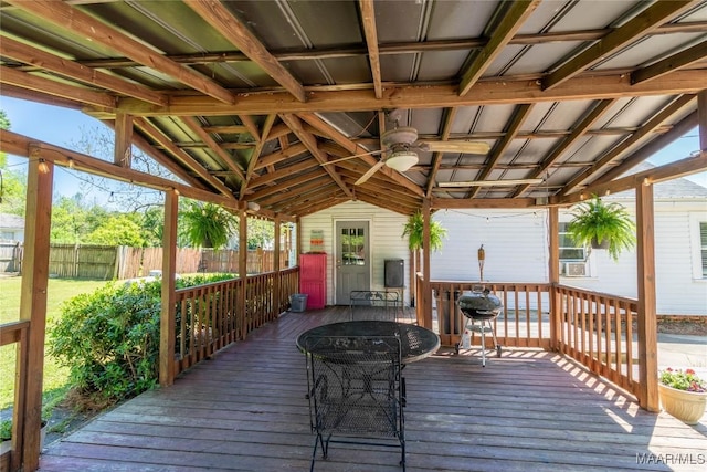 deck featuring a gazebo, fence, and outdoor dining area