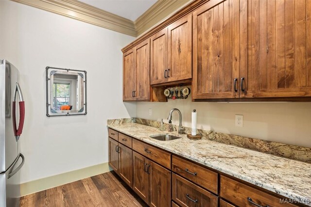 177 Tankersley Rd, Wetumpka, AL 36092 - kitchen featuring freestanding refrigerator, light stone countertops, ornamental molding, a sink, and dark wood-style floors
