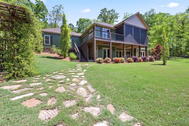 177 Tankersley Rd, Wetumpka, AL 36092 - back of house featuring stairs, a wooden deck, a sunroom, and a lawn
