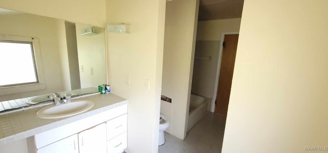 bathroom featuring toilet, vanity, and shower / washtub combination