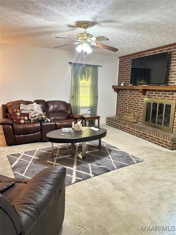 3041 Willow Lane Dr, Montgomery, AL 36109 - living room with a ceiling fan, a brick fireplace, and a textured ceiling