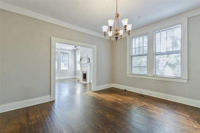 323 Finley Ave, Montgomery, AL 36104 - unfurnished dining area featuring a chandelier, baseboards, dark wood finished floors, and visible vents