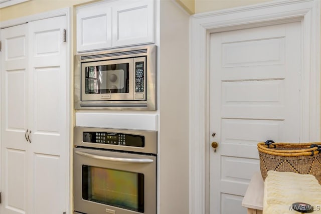 kitchen with stainless steel appliances and white cabinetry