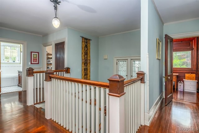 corridor featuring crown molding, wood-type flooring, and an upstairs landing