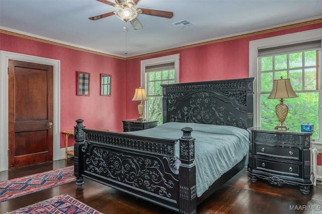bedroom featuring visible vents, multiple windows, and hardwood / wood-style floors