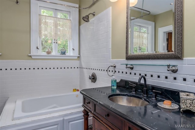 bathroom with vanity, a bath, and decorative backsplash