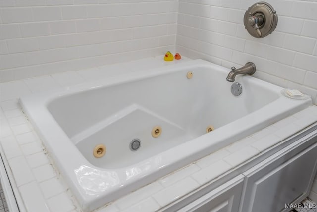 full bath featuring a tub with jets