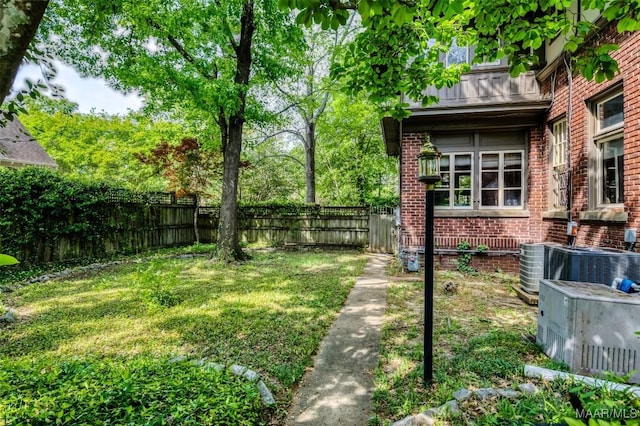 view of yard featuring central AC unit and a fenced backyard