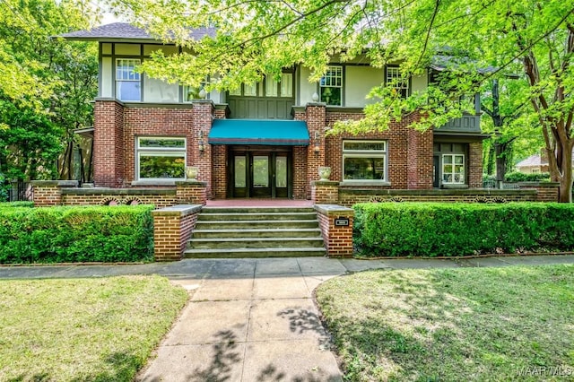 view of front of home with french doors, board and batten siding, and brick siding