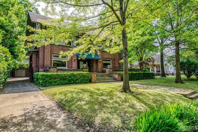 exterior space with a front yard and brick siding