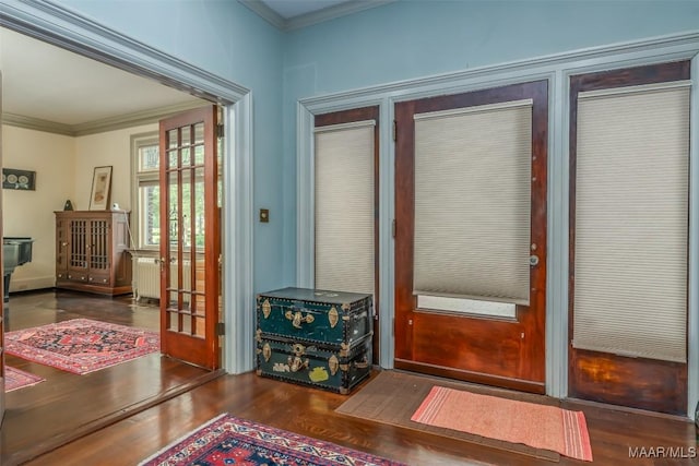 doorway to outside featuring crown molding and wood finished floors