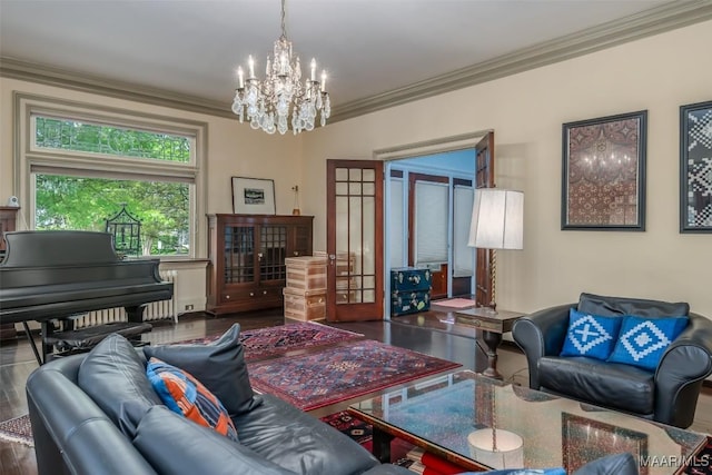 interior space featuring french doors, ornamental molding, an inviting chandelier, and wood finished floors