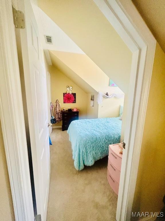 bedroom featuring light carpet and visible vents