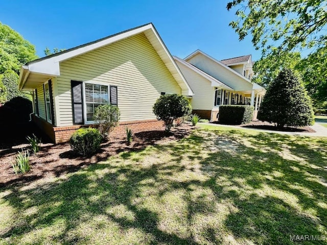 view of property exterior with a lawn