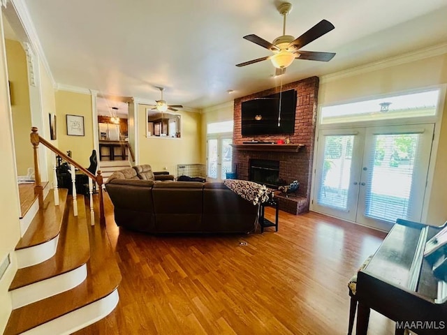 living area featuring ornamental molding, ceiling fan, and wood finished floors
