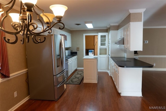 kitchen with stainless steel fridge, white cabinetry, and dark wood-type flooring