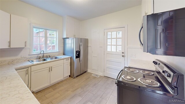 2045 Gorgas St, Montgomery, AL 36106 - kitchen featuring white cabinets, visible vents, appliances with stainless steel finishes, a sink, and light wood finished floors