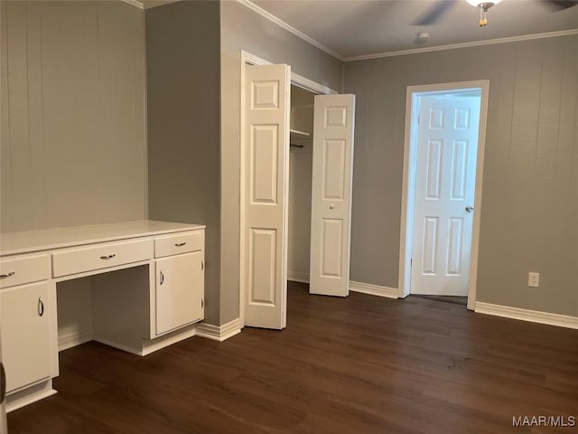 unfurnished bedroom with ornamental molding, baseboards, and dark wood finished floors