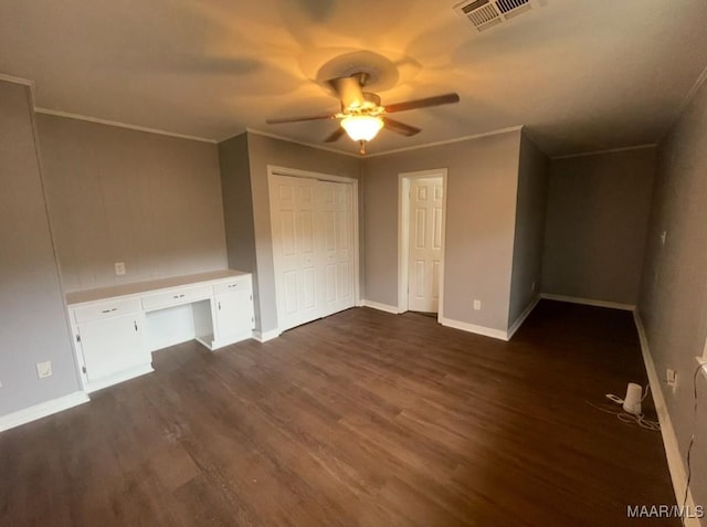unfurnished bedroom featuring visible vents, baseboards, and dark wood-style floors