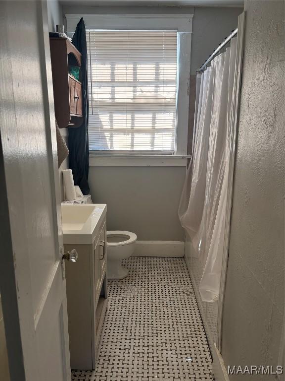 305 Federal Dr, Montgomery, AL 36107 - full bathroom with toilet, tile patterned floors, a shower with curtain, and vanity