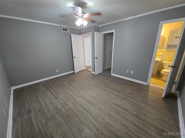 unfurnished bedroom featuring visible vents, ornamental molding, baseboards, and dark wood-style flooring