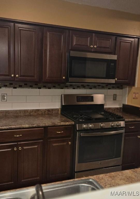 3313 Cross Creek Dr, Montgomery, AL 36116 - kitchen featuring dark countertops, decorative backsplash, stainless steel appliances, and dark brown cabinets
