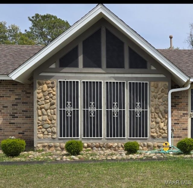 3313 Cross Creek Dr, Montgomery, AL 36116 - rear view of house with stone siding, brick siding, and roof with shingles