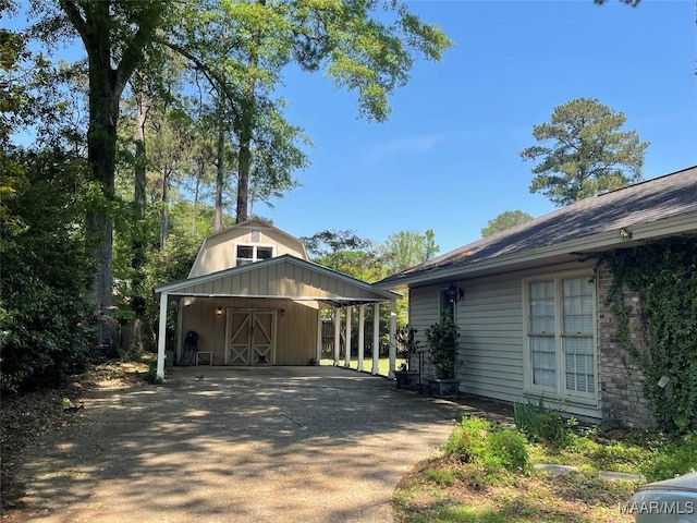 exterior space with driveway and a carport