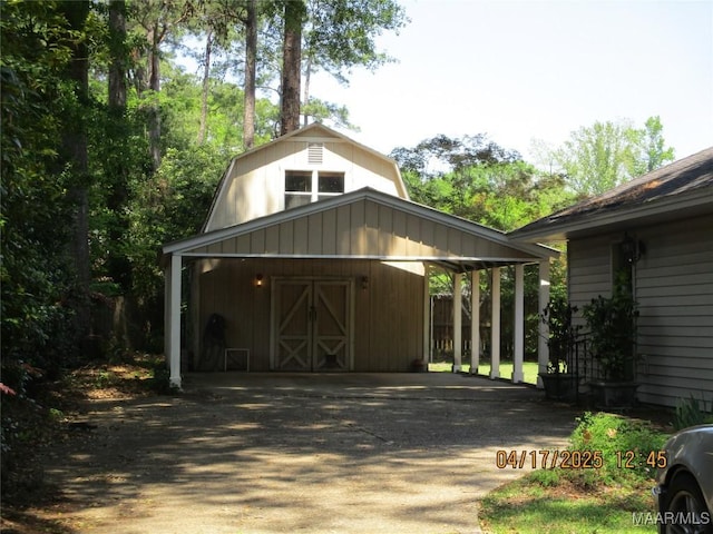 view of barn featuring driveway