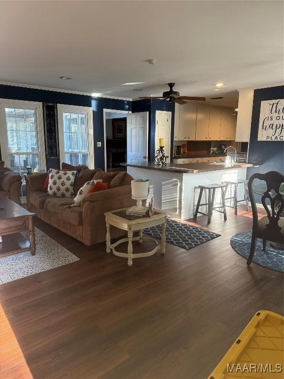 living room featuring wood finished floors and a ceiling fan
