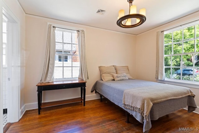 374 Rose Ln, Montgomery, AL 36104 - bedroom featuring wood finished floors, ornamental molding, baseboards, a notable chandelier, and visible vents
