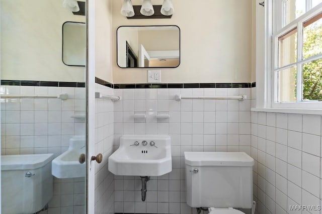 374 Rose Ln, Montgomery, AL 36104 - bathroom with tile walls, a wainscoted wall, a sink, and toilet
