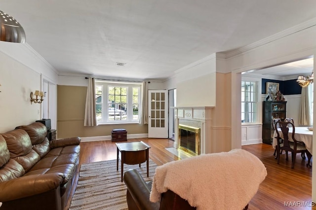 374 Rose Ln, Montgomery, AL 36104 - living room with visible vents, an inviting chandelier, wood finished floors, ornamental molding, and a high end fireplace