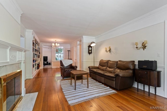 374 Rose Ln, Montgomery, AL 36104 - living room featuring an inviting chandelier, ornamental molding, hardwood / wood-style floors, and a premium fireplace