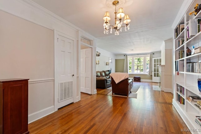 374 Rose Ln, Montgomery, AL 36104 - living room with baseboards, visible vents, a notable chandelier, wood finished floors, and ornamental molding