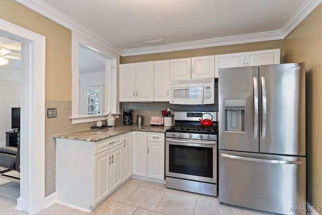 374 Rose Ln, Montgomery, AL 36104 - kitchen with ornamental molding, appliances with stainless steel finishes, and white cabinetry