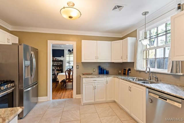 374 Rose Ln, Montgomery, AL 36104 - kitchen featuring visible vents, a sink, crown molding, decorative backsplash, and appliances with stainless steel finishes