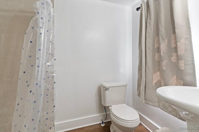 374 Rose Ln, Montgomery, AL 36104 - bathroom with toilet, baseboards, a sink, and a shower with curtain