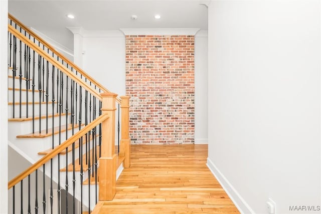 6432 Wynwood Pl, Montgomery, AL 36117 - stairway with wood finished floors, crown molding, brick wall, recessed lighting, and baseboards