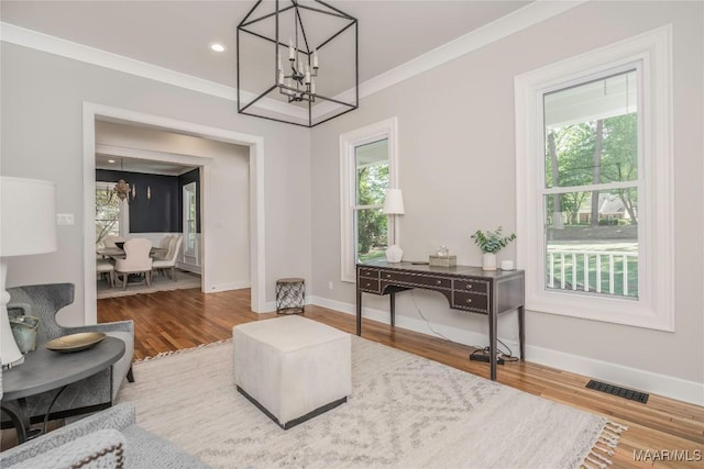 6432 Wynwood Pl, Montgomery, AL 36117 - living area with a chandelier, healthy amount of natural light, wood finished floors, baseboards, and crown molding