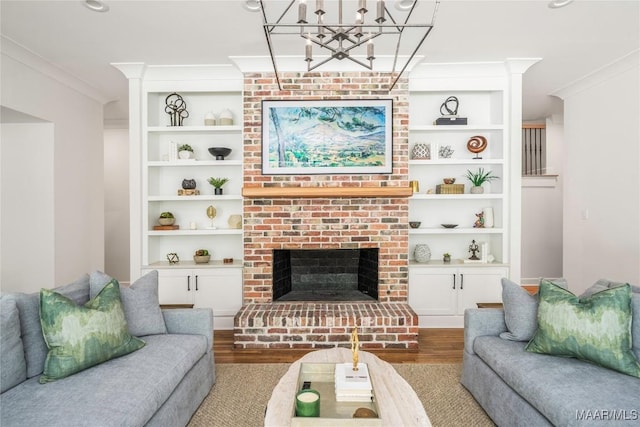 6432 Wynwood Pl, Montgomery, AL 36117 - living area with wood finished floors, a chandelier, crown molding, built in features, and a brick fireplace