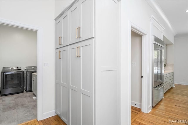 6432 Wynwood Pl, Montgomery, AL 36117 - hall featuring washing machine and clothes dryer, light wood-type flooring, and baseboards