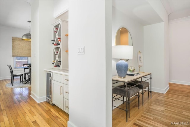 6432 Wynwood Pl, Montgomery, AL 36117 - corridor featuring light wood-style flooring, crown molding, wine cooler, and baseboards
