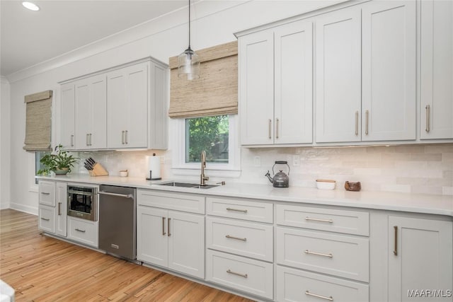 6432 Wynwood Pl, Montgomery, AL 36117 - kitchen featuring stainless steel dishwasher, a sink, light countertops, decorative backsplash, and crown molding